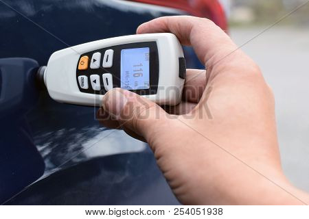 Measuring Thickness Of The Car Paint Coating With Paint Thickness Gauge.