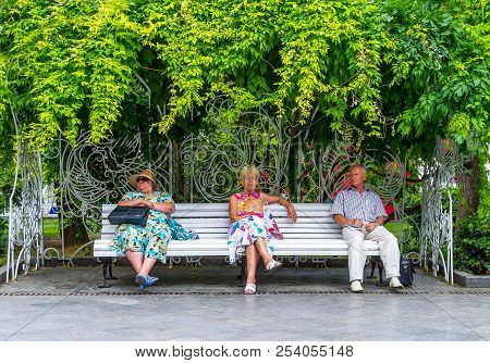 Jalta, Ukraine - August 16, 2012: Local People People Sitting On A Bench In The Waterfront Pedestria