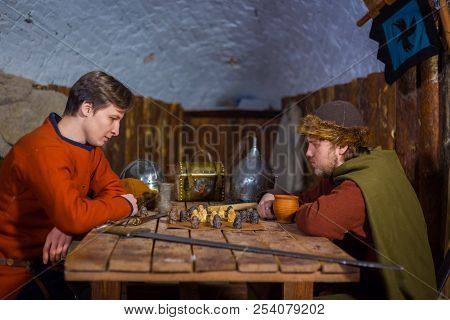 Two Men Playing Popular Strategy Board Game - Tafl