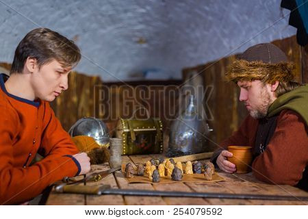 Two Men Playing Popular Strategy Board Game - Tafl