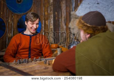 Two Men Playing Popular Strategy Board Game - Tafl