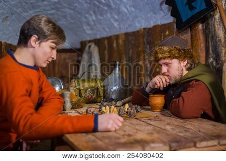 Two Men Playing Popular Strategy Board Game - Tafl