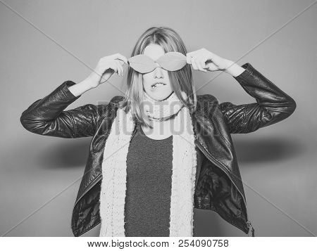 Beauty And Fashion. Woman With Autumn Leaves As Glasses In Leather Jacket. Girl With Orange Leaves O