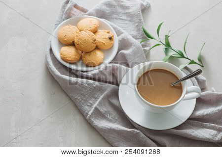 Closeup Of Coffee With Milk In White Cup And Tasty Cookies. Shot On Light Stone Background