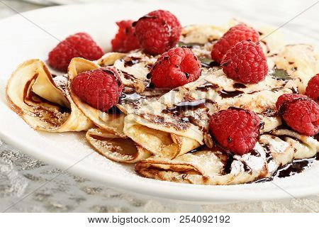 Delicious Golden Palacinky Pancakes Or Czech Pancakes With Fresh Raspberries And Sweet Chocolate Syr