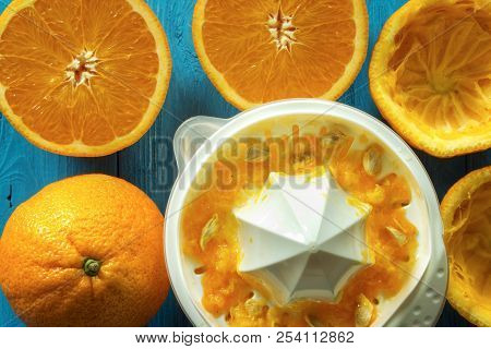 Squeezing Orange Juice , Oranges With Manual Hand Juicer On Rustic Table , Closeup , Top View