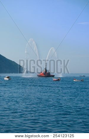 Naval Vessel Of Firefighters With High Splashes Of Sea Water
