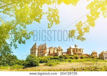 Historic Biron Castle In France Under Blue Sky