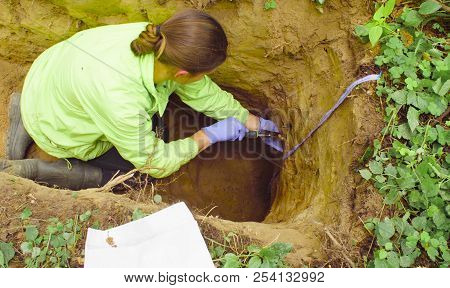 Woman Ecologist Taking Samples Of A Soil