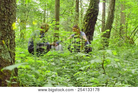 Woman And Man Ecologists Taking Samples Of A Soil