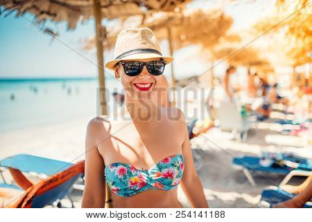 Summer Lifestyle Portrait Of Pretty Happy Girl With Tanned Sexy Body, Wearing Strawhat And Sunglasse