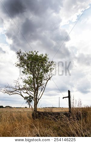 Old Pump With Dry Soil, Dramatic Cloudy Sky, Water Shortage