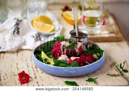 Beet Falafel With Tahina  Sauce And Green . Salad Selective Focus