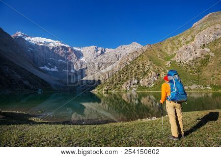 Wanderlust time. Man hiking in beautiful Fann mountains in Pamir, Tajikistan. Central Asia.