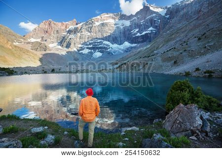 Wanderlust time. Man hiking in beautiful Fann mountains in Pamir, Tajikistan. Central Asia.