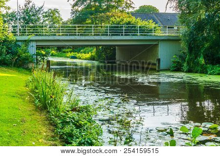Stone Bridge To Cross Over The River In A Water Landscape