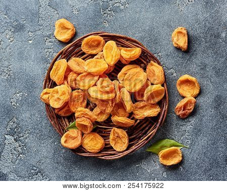 Dried Apricots On Gray Concrete Background With Copy Space. Top View.