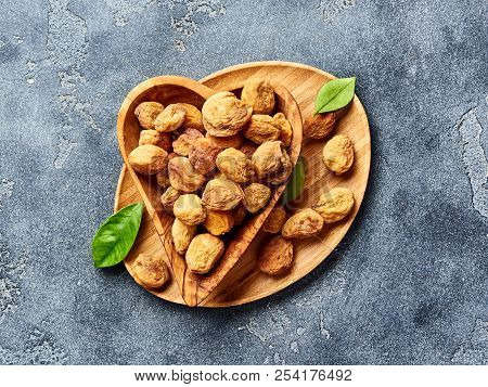Sun Dried Apricots On Gray Concrete Background. Top View.
