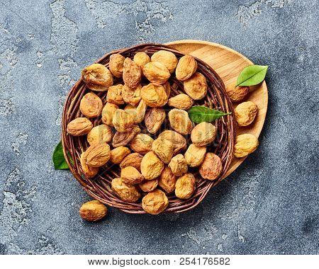 Sun Dried Apricots On Gray Concrete Background. Top View.