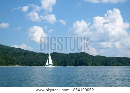 White yacht on Solina lake, Poland. Landscape photography