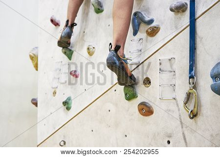 Woman Training On A Climbing Wall In Sport Hall, Close-up Of Shoes, Ready To Workout