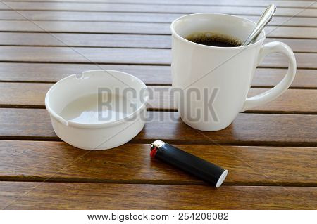 A White Ceramic Cup With A Morning Refreshing Hot Coffee With Tea Drink And Tea Shiny Teaspoon And A