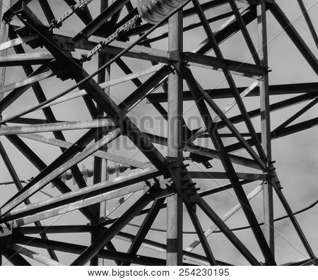 Fragment Of High-voltage Tower. Power Line. Metalware. Black And White Photo. Bnw. Urban Grunge