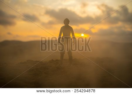Silhouette Of Military Soldier Or Officer With Weapons At Sunset. Shot, Holding Gun, Colorful Sky, M