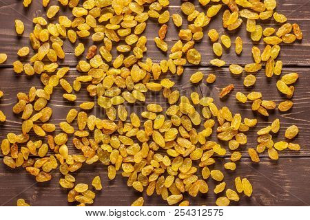 Lot Of Whole Dry Golden Raisins Sultana Variety Flatlay On Brown Wood