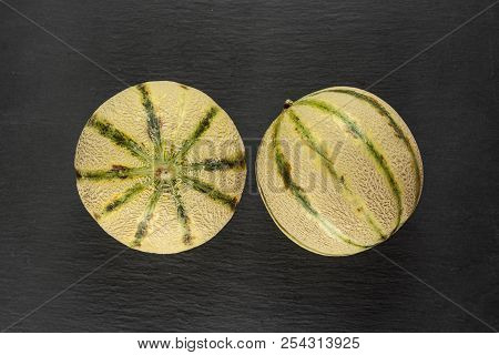 Group Of Two Whole Fresh Melon Cantaloupe Variety Flatlay On Grey Stone