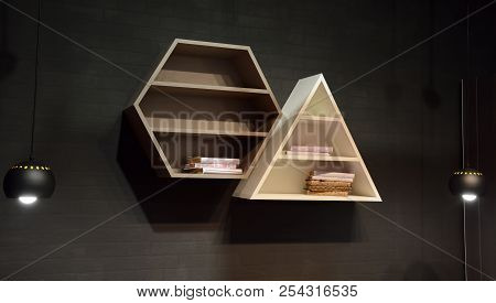 Modern Wooden Shelves On Dark Grey Wall Brick Backgrond With Fashion Lamps. Trendy Design