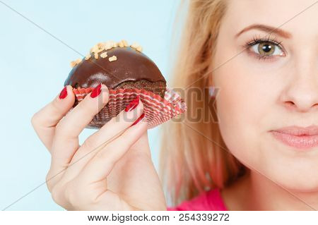 Diet, Sweets, Food Concept. Woman Holding Delicious Chocolate Cupcake With Peanut Frosting About To 