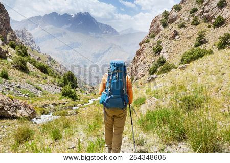 Wanderlust time. Man hiking in beautiful Fann mountains in Pamir, Tajikistan. Central Asia.