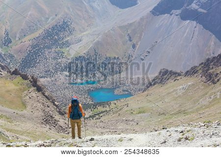 Wanderlust time. Man hiking in beautiful Fann mountains in Pamir, Tajikistan. Central Asia.
