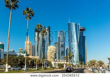 Doha, Qatar - Jan 8th 2018 - The Modern Downtown Of Doha City With Palm Tree With Cars In A Wide Ave