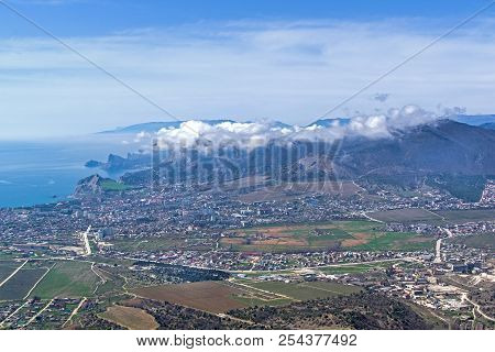 The Tops Of The Mountains Are Covered With Clouds. View From The Top Of Mount Ai-george (the Western