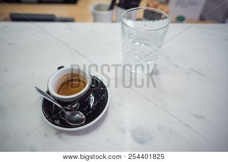 Coffee Mug And A Glass Of Water On A Table