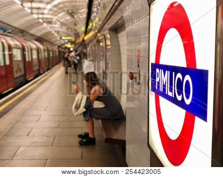 LONDON - AUGUST 19, 2018: Passengers waiting on the platform for the doors to open on an arriving train at Pimlico underground station on the Victoria line in Pimlico, London.