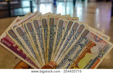 Hand Holding Myanmar Banknotes (mm, Mmr, Kyat). Currency Background.