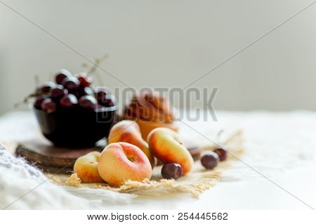 Homemade Cinnamon Buns In Glaze On A Dark Plate With Berries