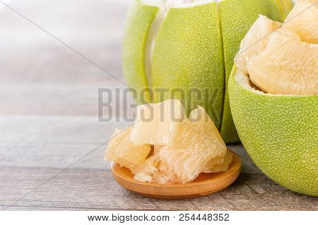 Fresh And Peeled Pomelo(shaddock), Grapefruit With Slices On Wooden Table Background