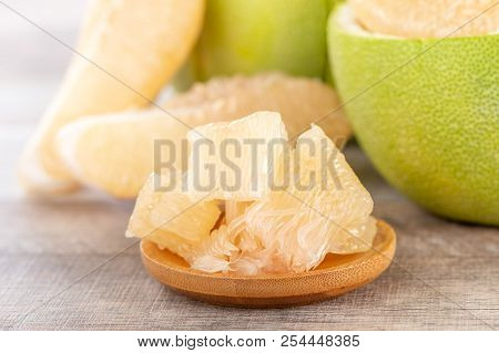 Fresh And Peeled Pomelo(shaddock), Grapefruit With Slices On Wooden Table Background
