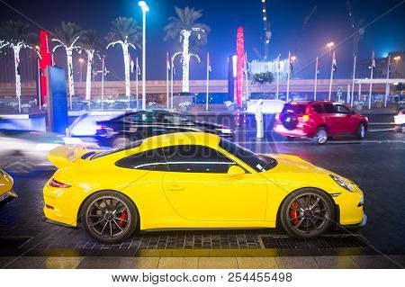 Dubai, Uae - December 23, 2017: Luxury Supercar Porsche 911 Carrera 4 Gts Yellow Color Parked Next T