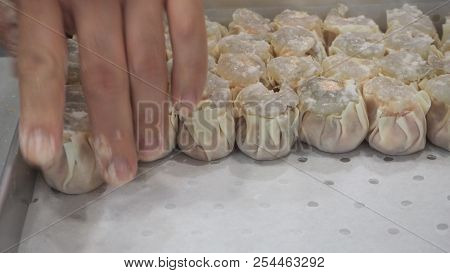 Blurry Image Of Man Or Chef Is Making Dim Sum. By Dumpling Wrappers.