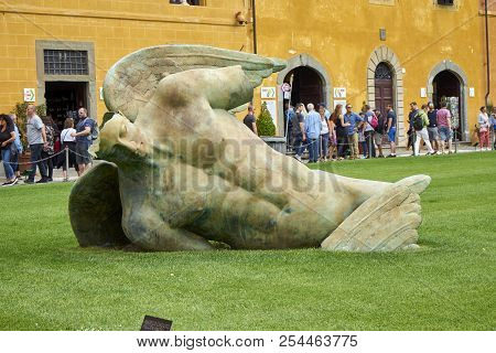 Pisa / Tuscany / Italy / May 2018 : Tourists Admire The Fallen Angel Statue By Igor Mitoraj