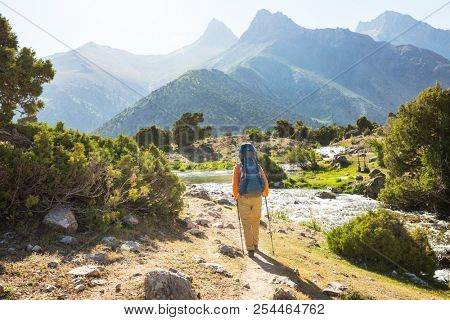 Wanderlust time. Man hiking in beautiful Fann mountains in Pamir, Tajikistan. Central Asia.