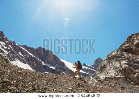 Wanderlust time. Man hiking in beautiful Fann mountains in Pamir, Tajikistan. Central Asia.