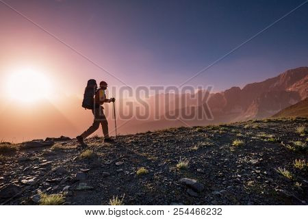 Wanderlust time. Man hiking in beautiful Fann mountains in Pamir, Tajikistan. Central Asia.