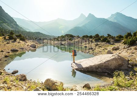 Wanderlust time. Man hiking in beautiful Fann mountains in Pamir, Tajikistan. Central Asia.