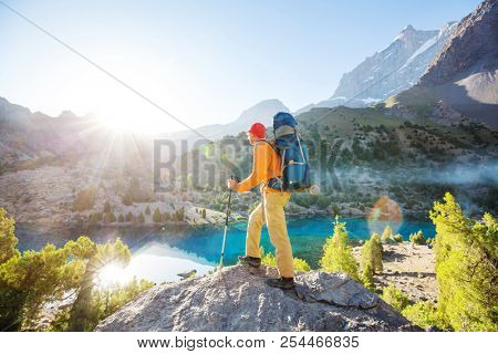 Wanderlust time. Man hiking in beautiful Fann mountains in Pamir, Tajikistan. Central Asia.
